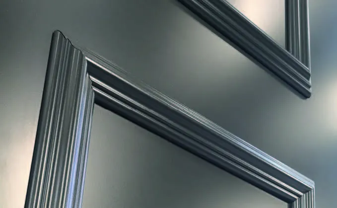 Close-up of a profiled aluminium door frame and architrave in a brushed gunmetal finish
