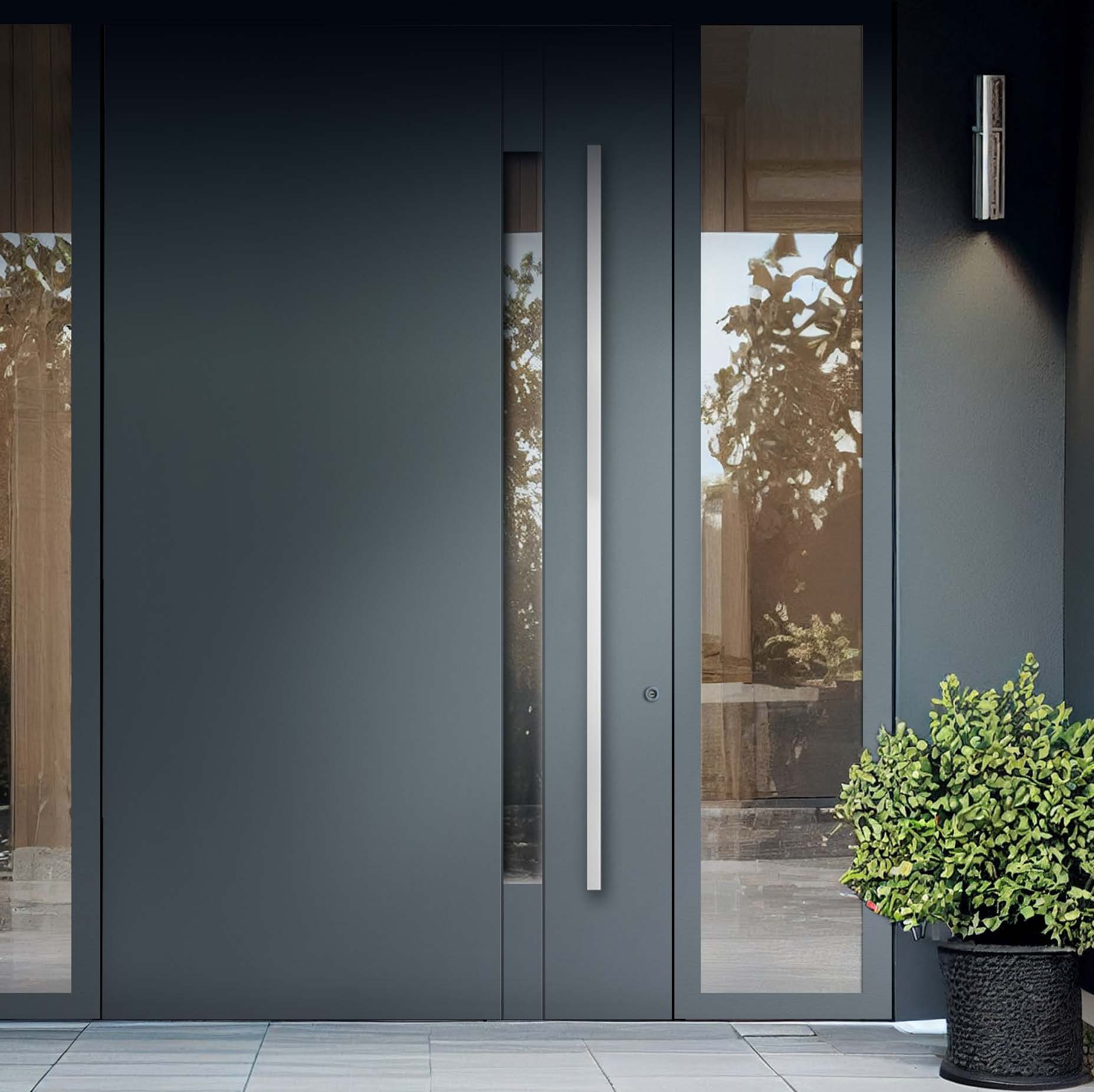 Architectural pivot front door framed by greenery